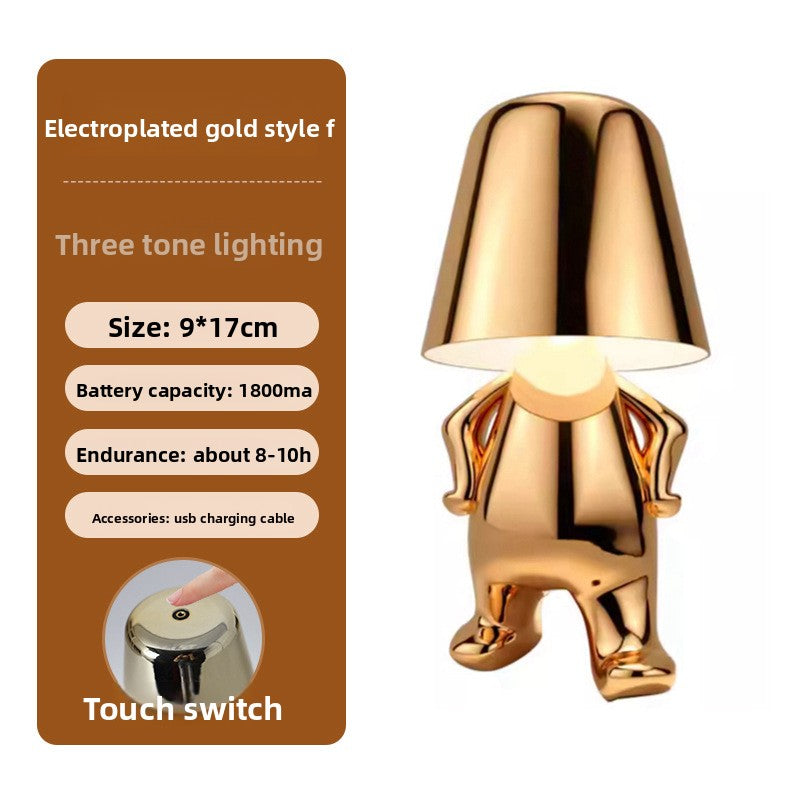 Tischlampe mit goldfarbener Figur