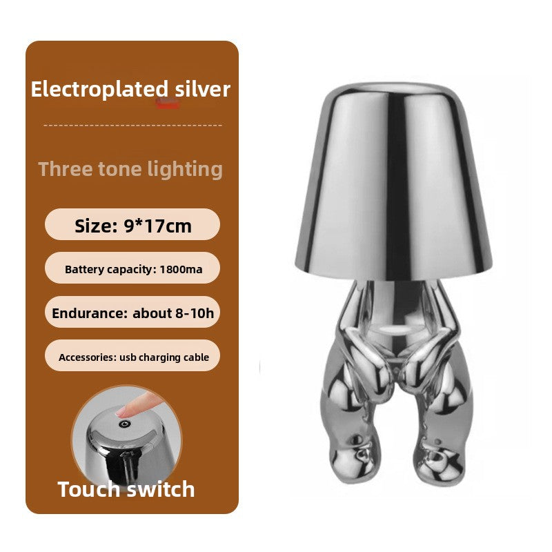 Tischlampe mit goldfarbener Figur