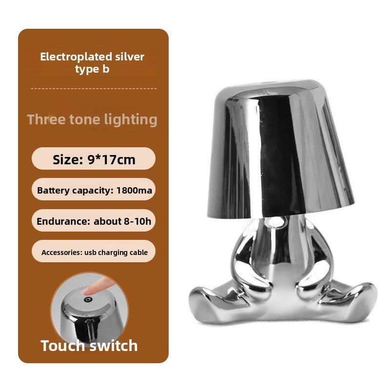 Tischlampe mit goldfarbener Figur