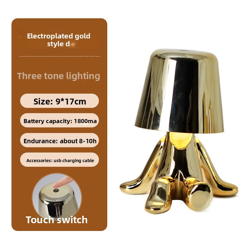 Tischlampe mit goldfarbener Figur
