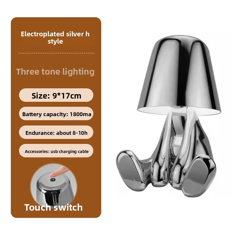 Tischlampe mit goldfarbener Figur