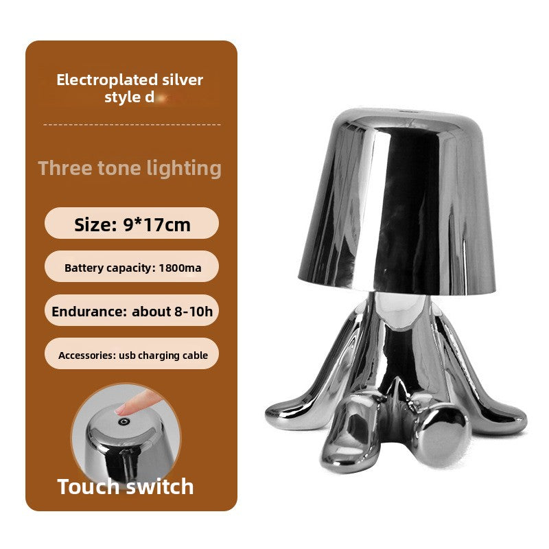 Tischlampe mit goldfarbener Figur